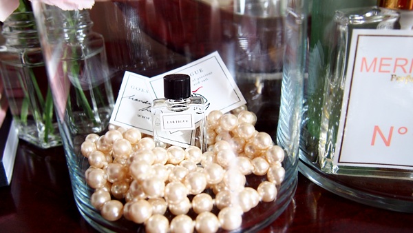 vanity table displaying perfume and jewelry