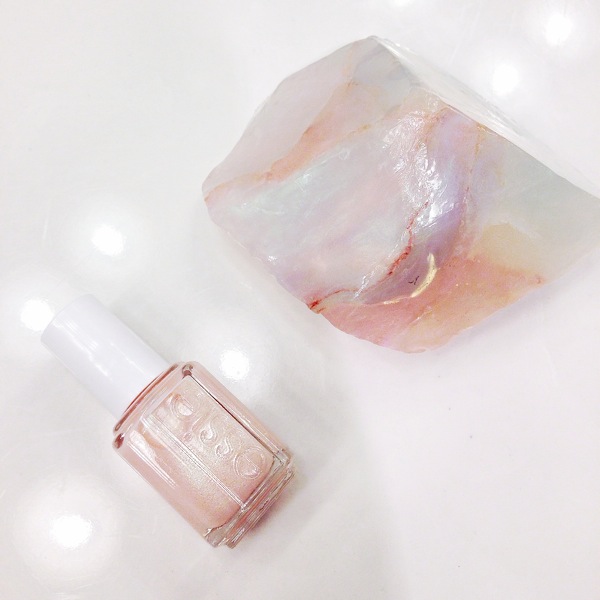 Essie brand nail polish in a nude pink shade with soap shaped like a gemstone