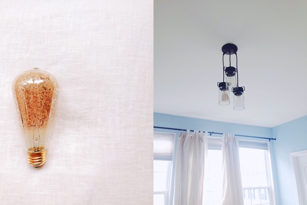 the light fixture not turned on and the antiqued edison bulb located in one of the fixtures speckled with metallic gold flakes