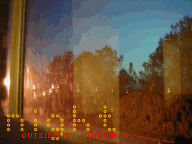night outside my window, the glow of the flood light that disappears into the open field